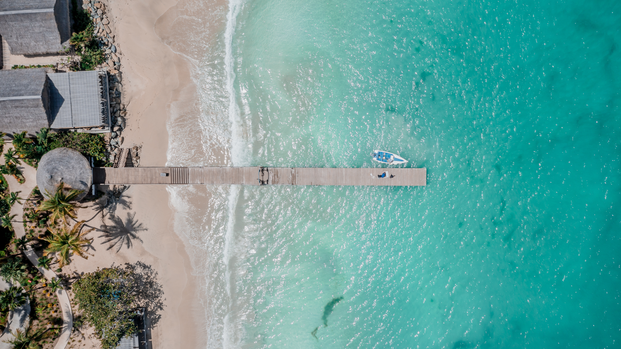 Soho Beach House Canouan aerial view over pier and crystal clear sea water below