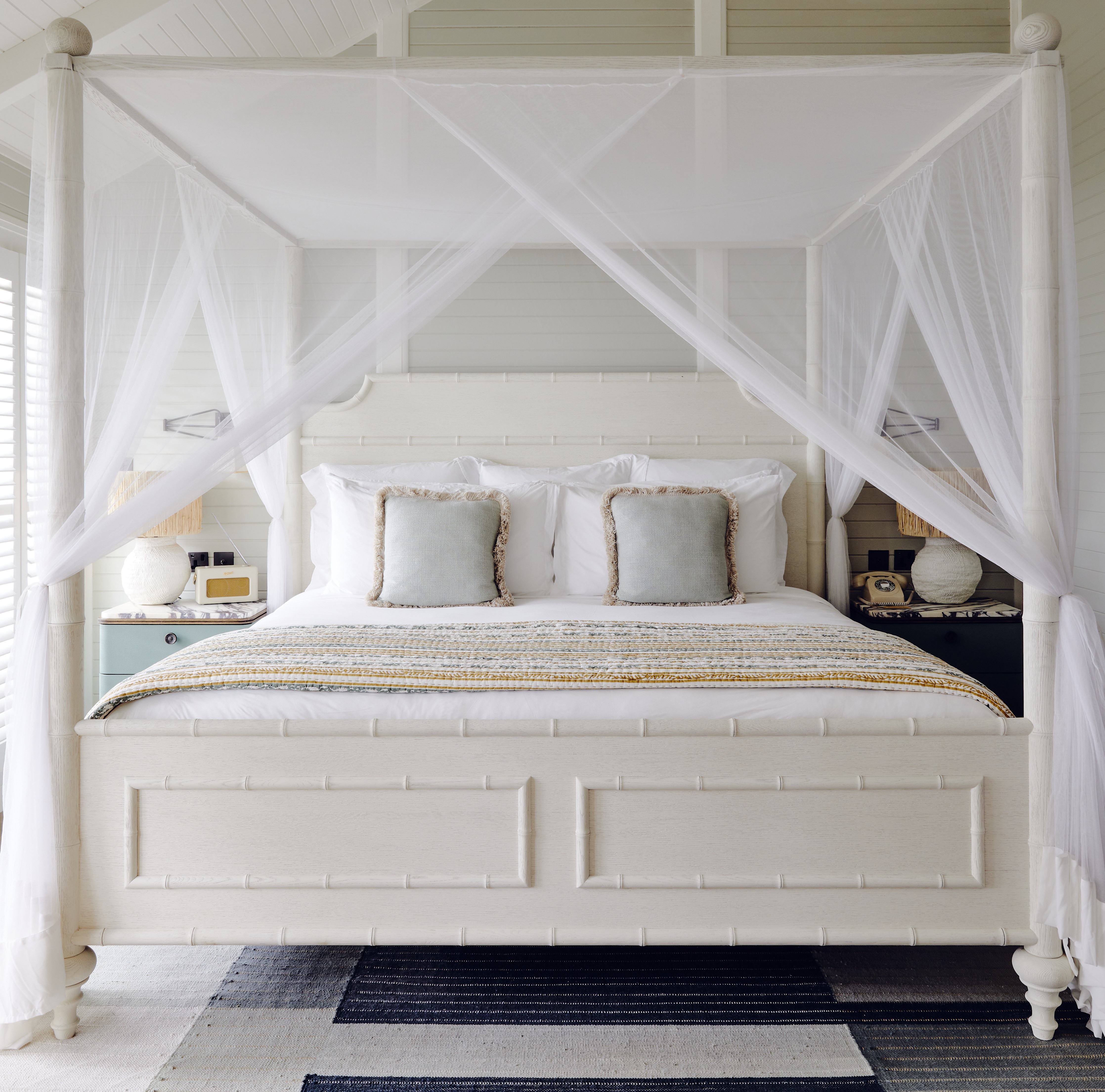 Soho Beach House Canouan bedroom with white four-poster bed and neutral sea-themed colours
