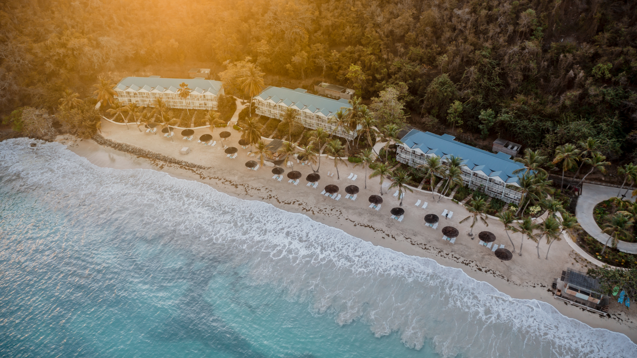 Soho Beach House Canouan aerial view showing hotel buildings on the beach