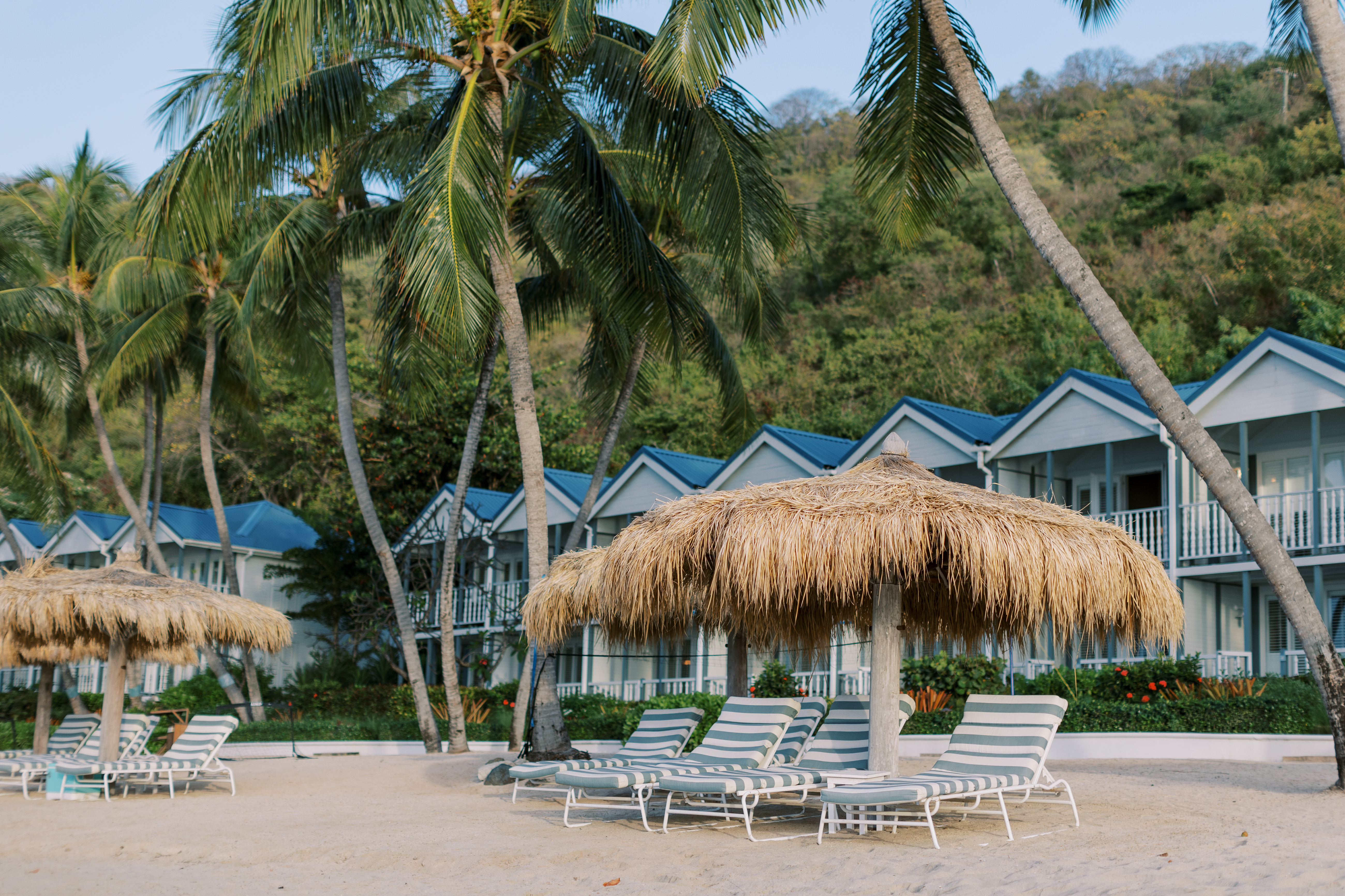 Soho Beach House Canouan hotel buildings, like beach huts lined against the sand