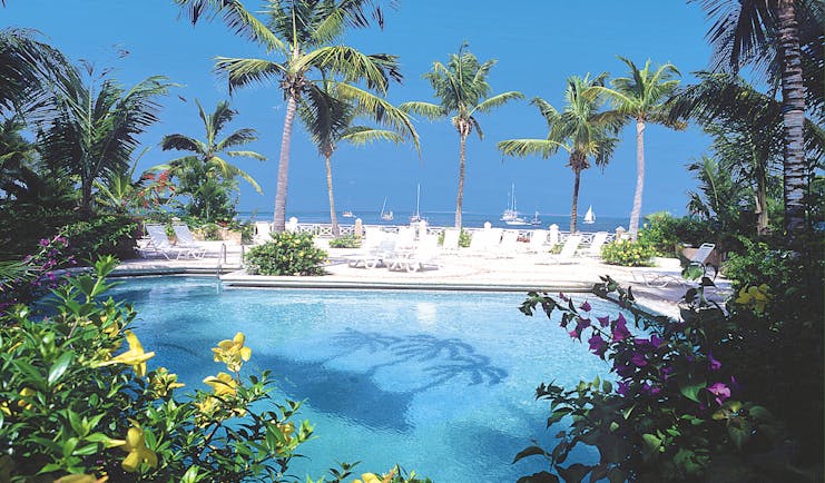 Coco Reef Tobago pool sun loungers palm trees view of ocean