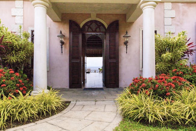 The Villas at Stonehaven Tobago villa entrance pink building shrubbery