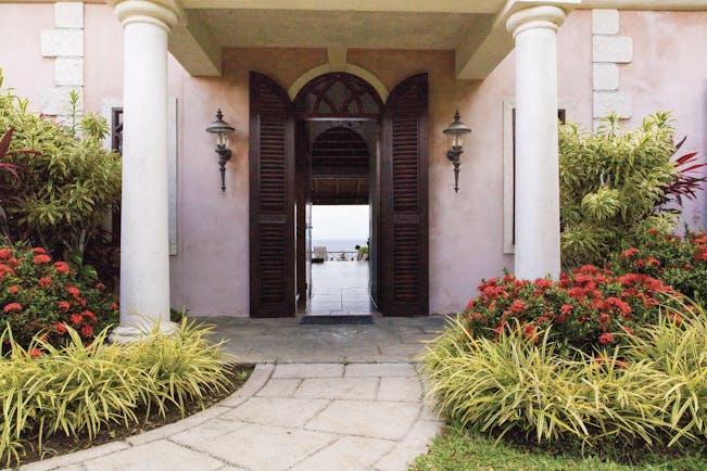 The Villas at Stonehaven Tobago villa entrance pink building shrubbery