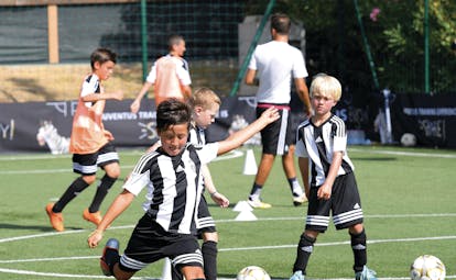 Boys in black and white shirts playing football