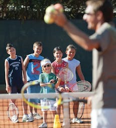 Group of children having tennis lesson