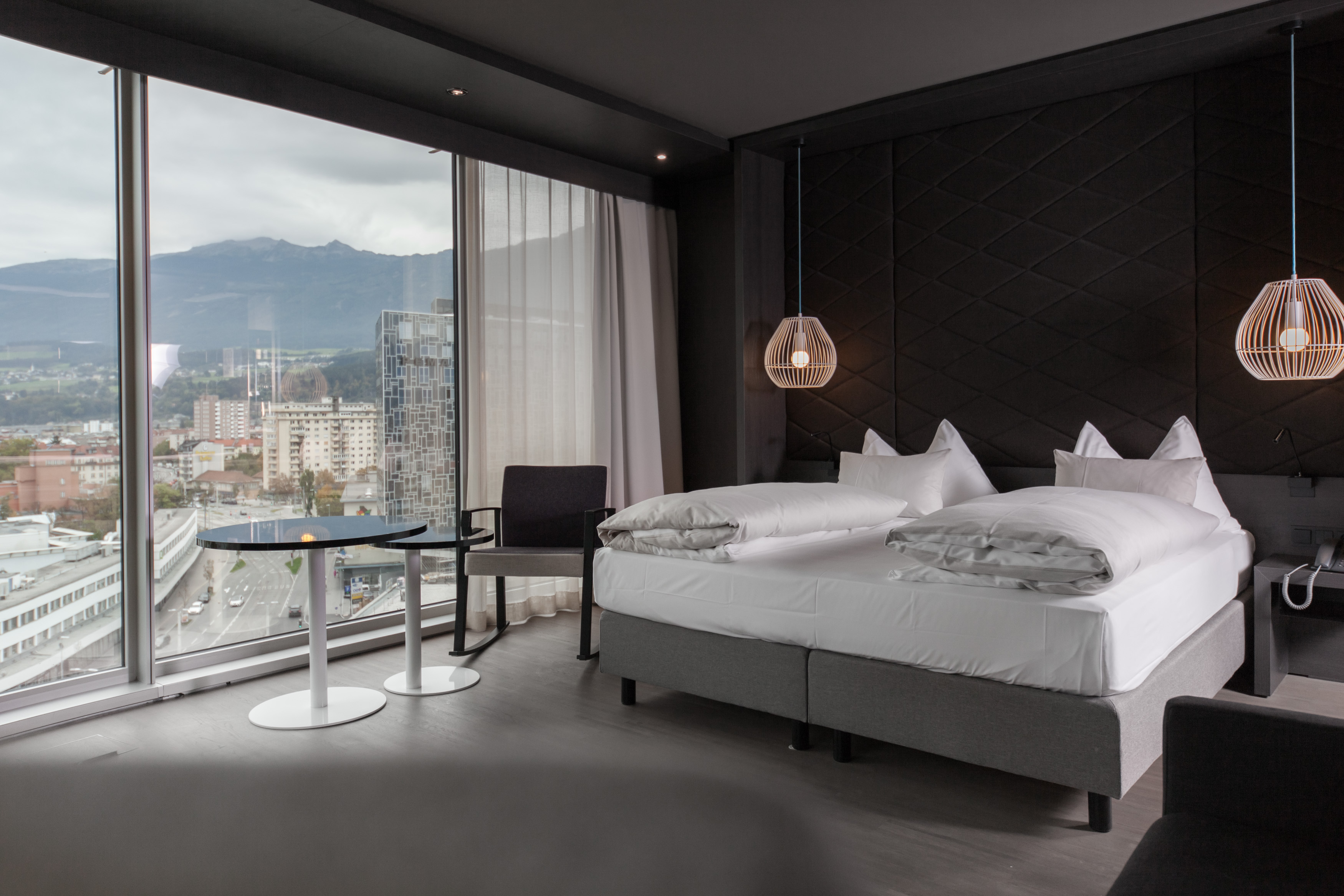 Adlers Hotel Austria large spacious room with a double bed and hanging lights