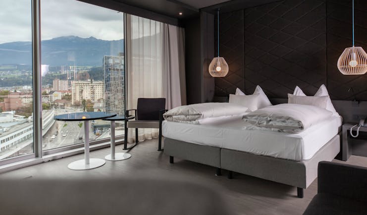 Adlers Hotel Austria large spacious room with a double bed and hanging lights