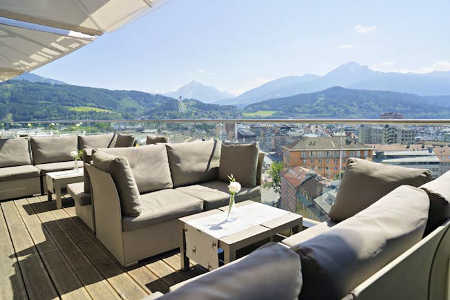 Adlers Hotel Austria outside seating with large sofas and tables on a wooden floor