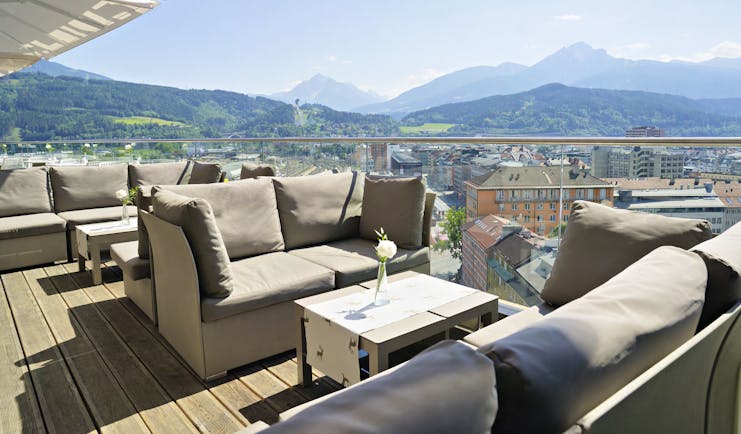 Adlers Hotel Austria outside seating with large sofas and tables on a wooden floor