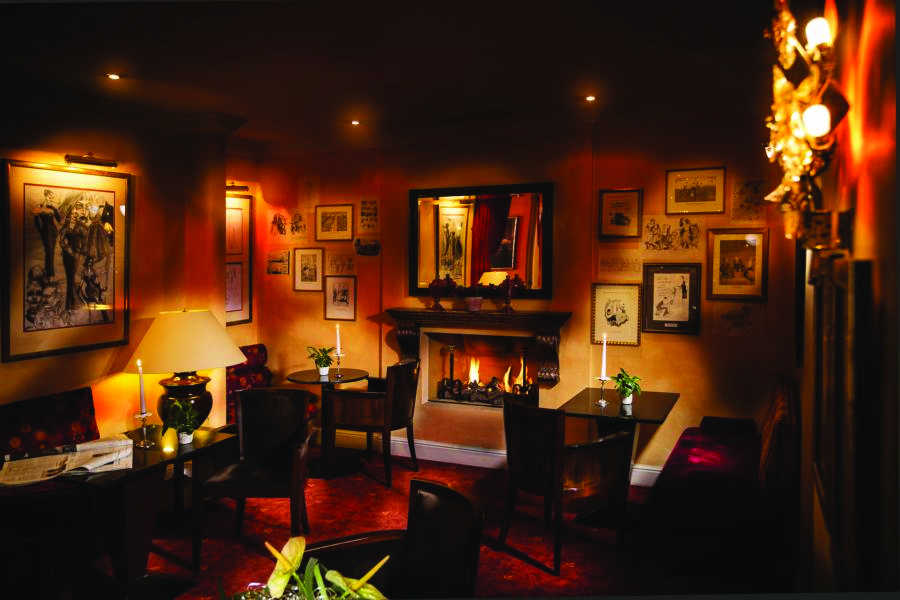 Hotel Bristol Salzburg bar with dim lighting, paintings on the walls and seating areas