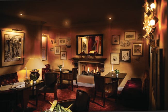 Hotel Bristol Salzburg bar with dim lighting, paintings on the walls and seating areas