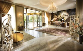 Hotel Bristol Salzburg lobby with grand chandelier, high ceilings, revolving entrance door and rug
