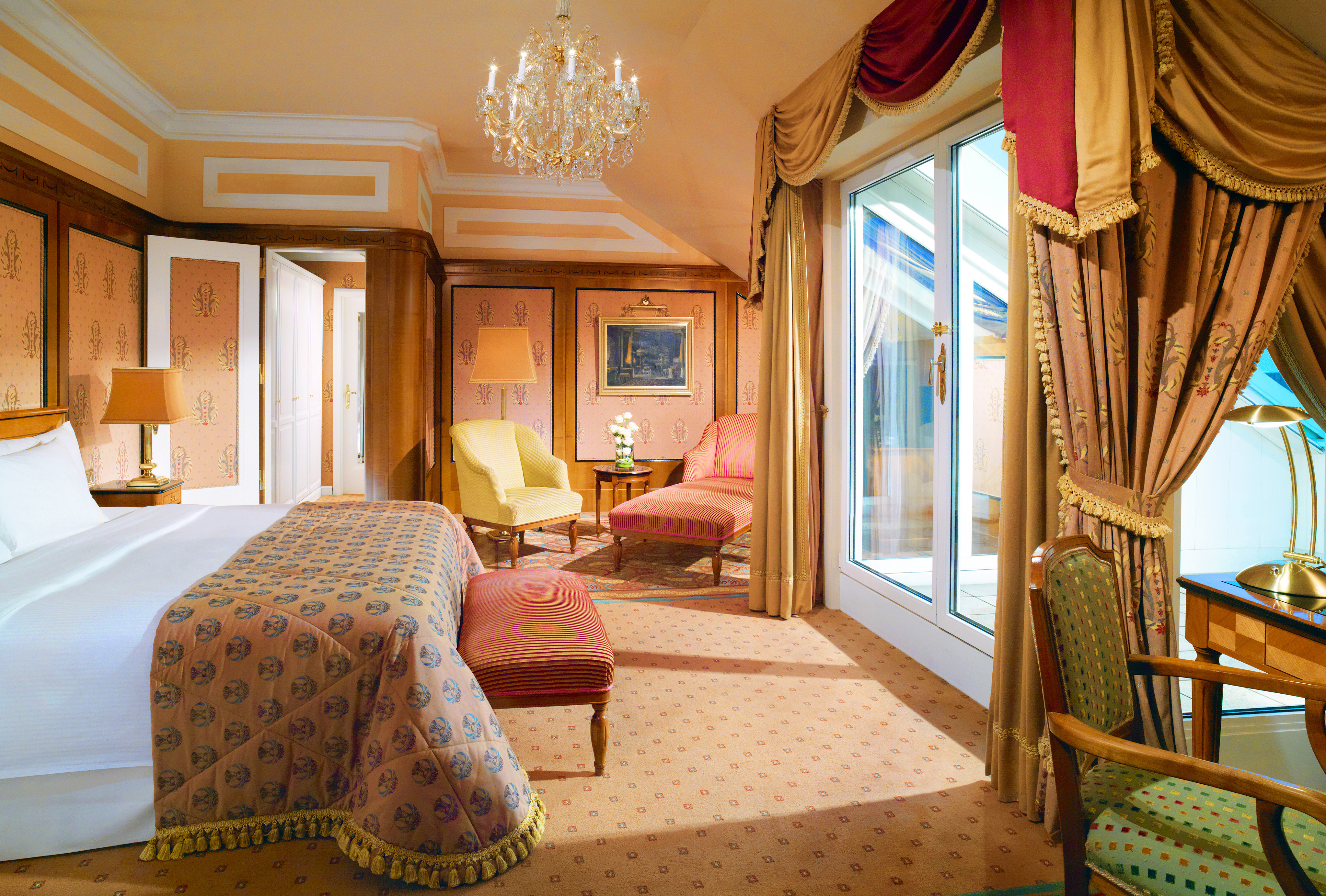 Hotel Bristol Austria Vienna junior suite with a large double bed within a spacious room with chairs in both corners of the room