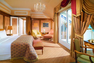 Hotel Bristol Austria Vienna junior suite with a large double bed within a spacious room with chairs in both corners of the room