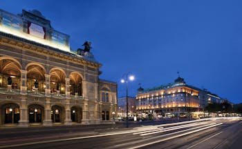 Hotel Bristol Vienna state opera house the hotel and a city street at night time
