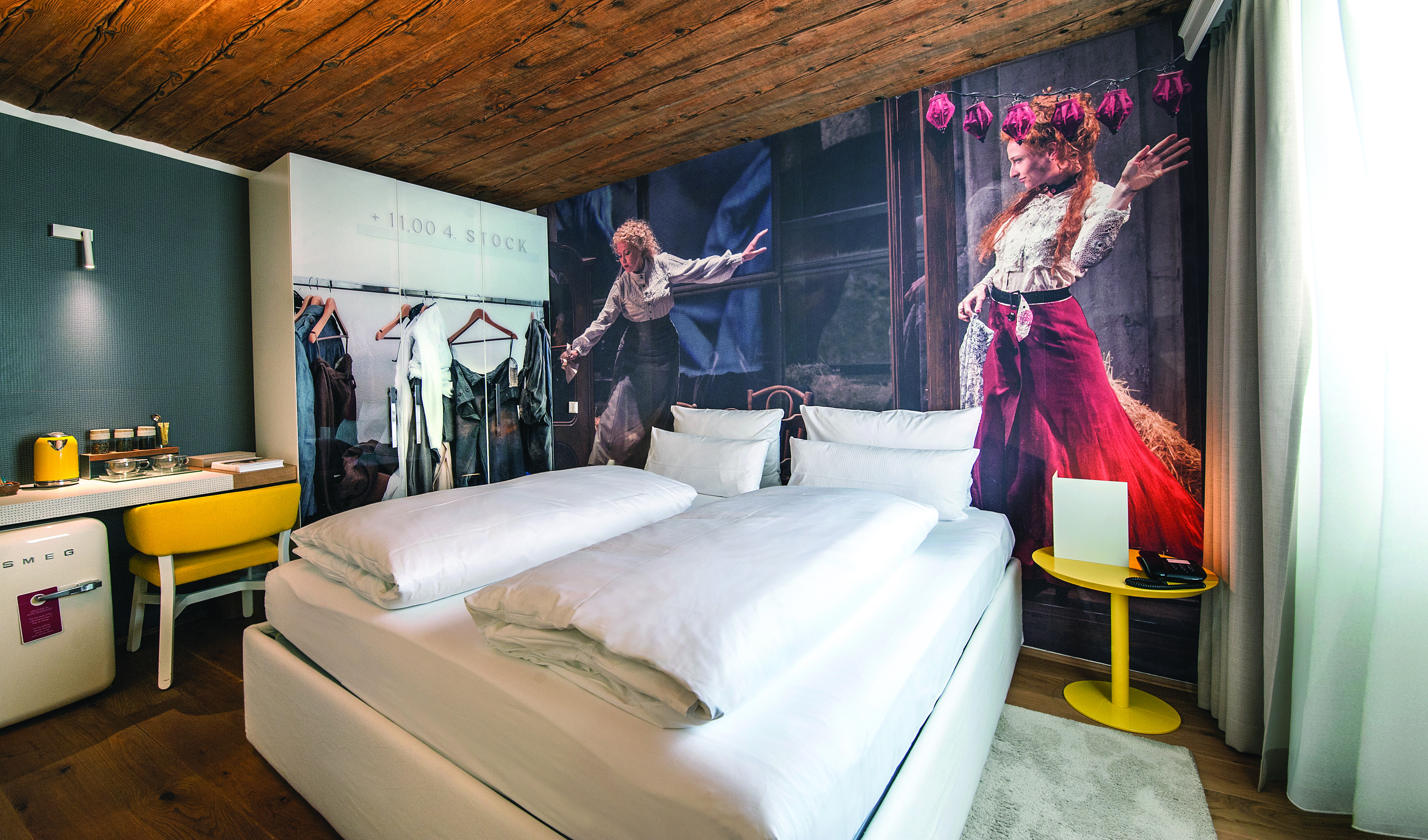 Hotel Goldgasse double bed within a modern stylised room