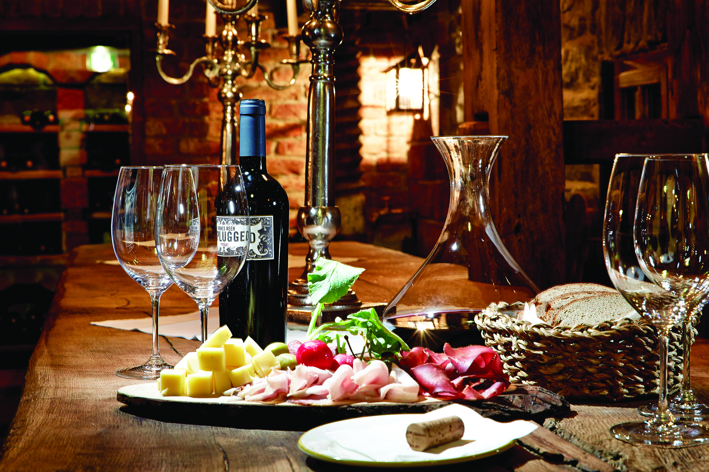 Food and wine laid out on a wooden table