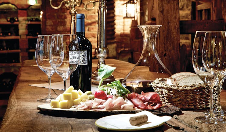 Food and wine laid out on a wooden table