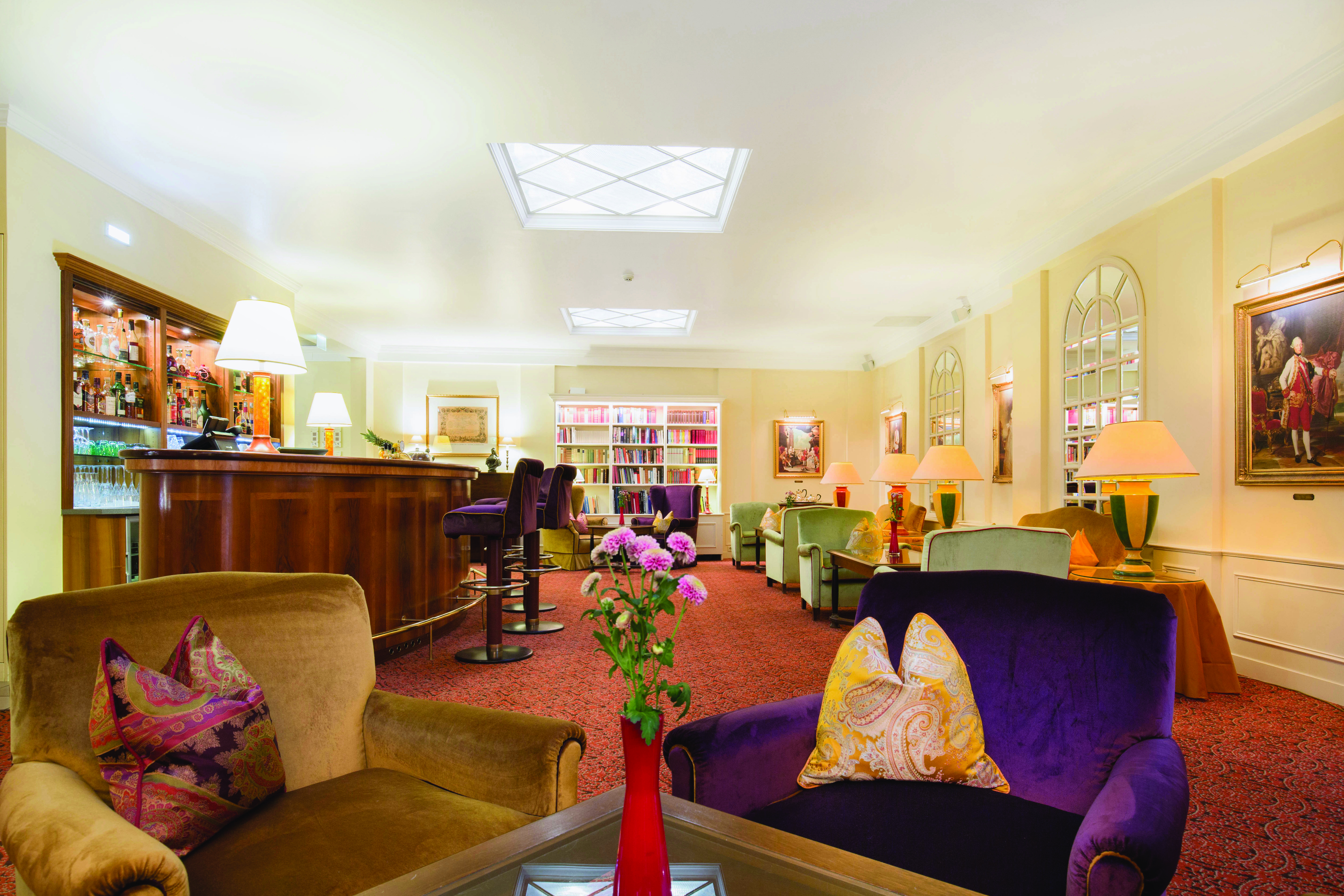 Hotel Kaiserhof Vienna bar lounge and bar area with armchairs paintings on the walls and wooden bar
