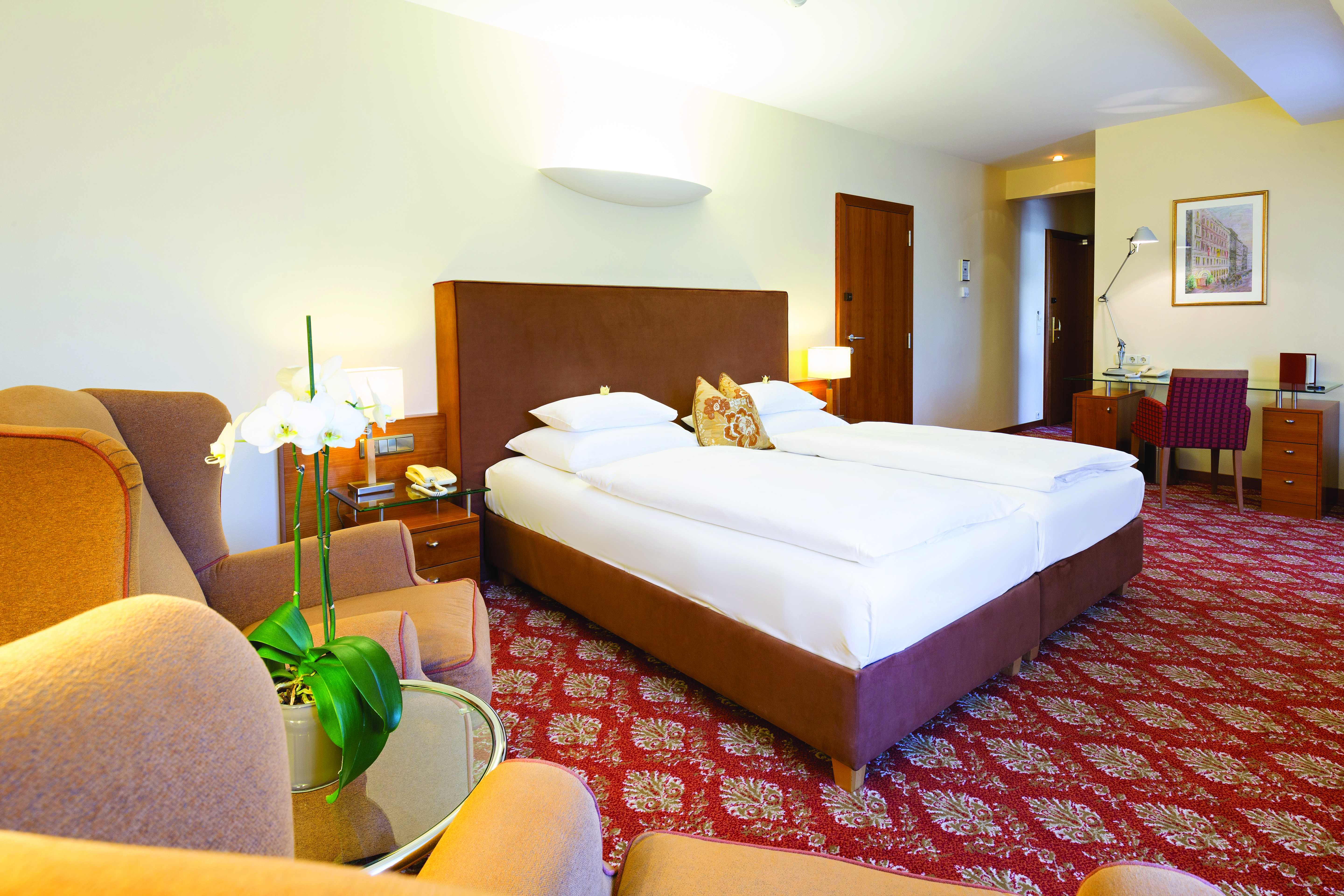 Hotel Kaiserhof Vienna junior suite bedroom red carpet armchair and desk