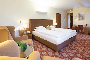 Hotel Kaiserhof Vienna junior suite bedroom red carpet armchair and desk