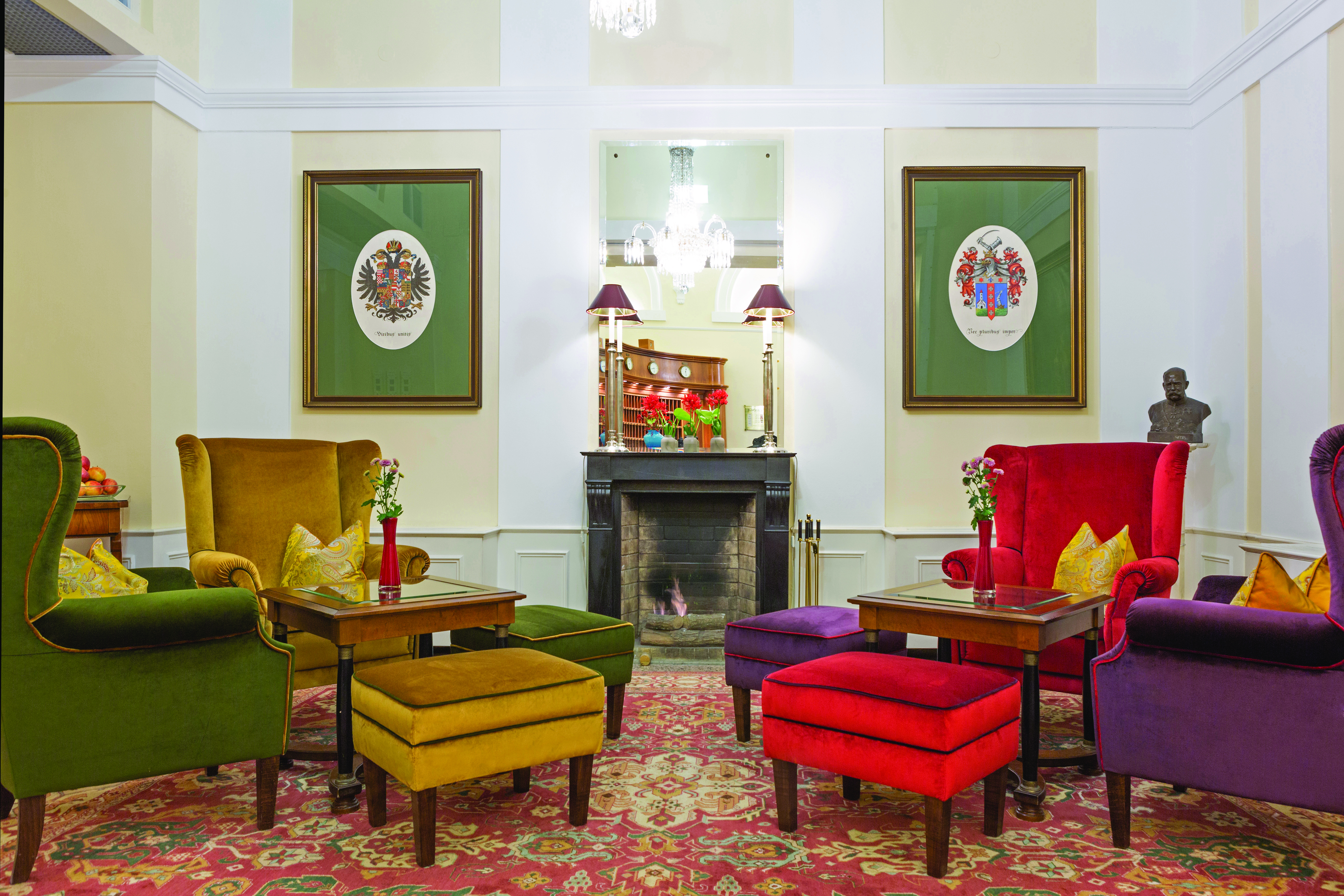 Hotel Kaiserhof Vienna lobby lounge area winged armchairs fireplace and two pictures of coats of arms
