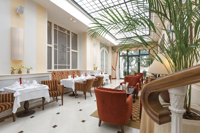 Hotel Kaiserhof Vienna winter garden conservatory room plants and comfortable seating