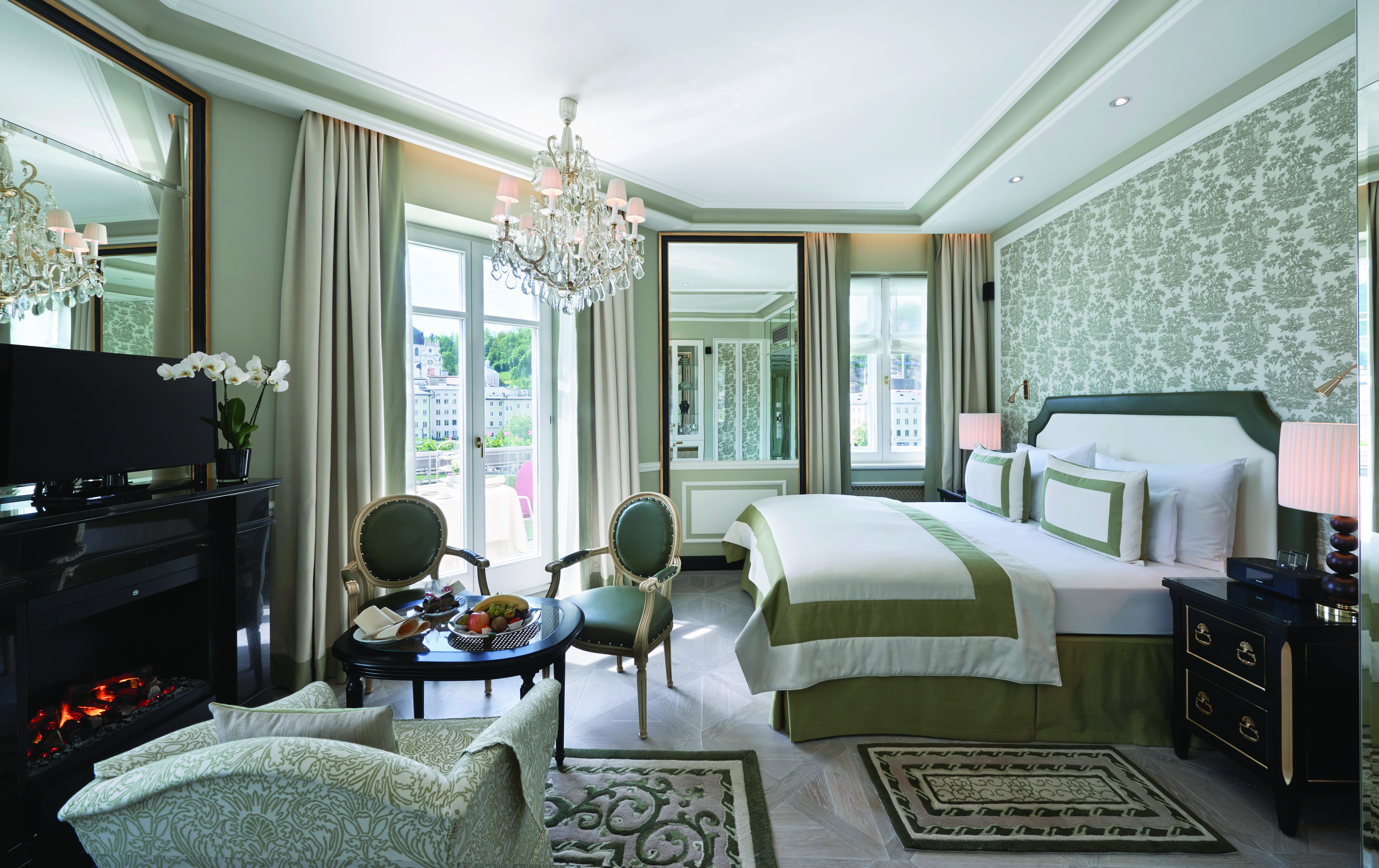 Hotel Sacher junipt suite, double bed, chairs, armchair, elegant decor, glass chandelier