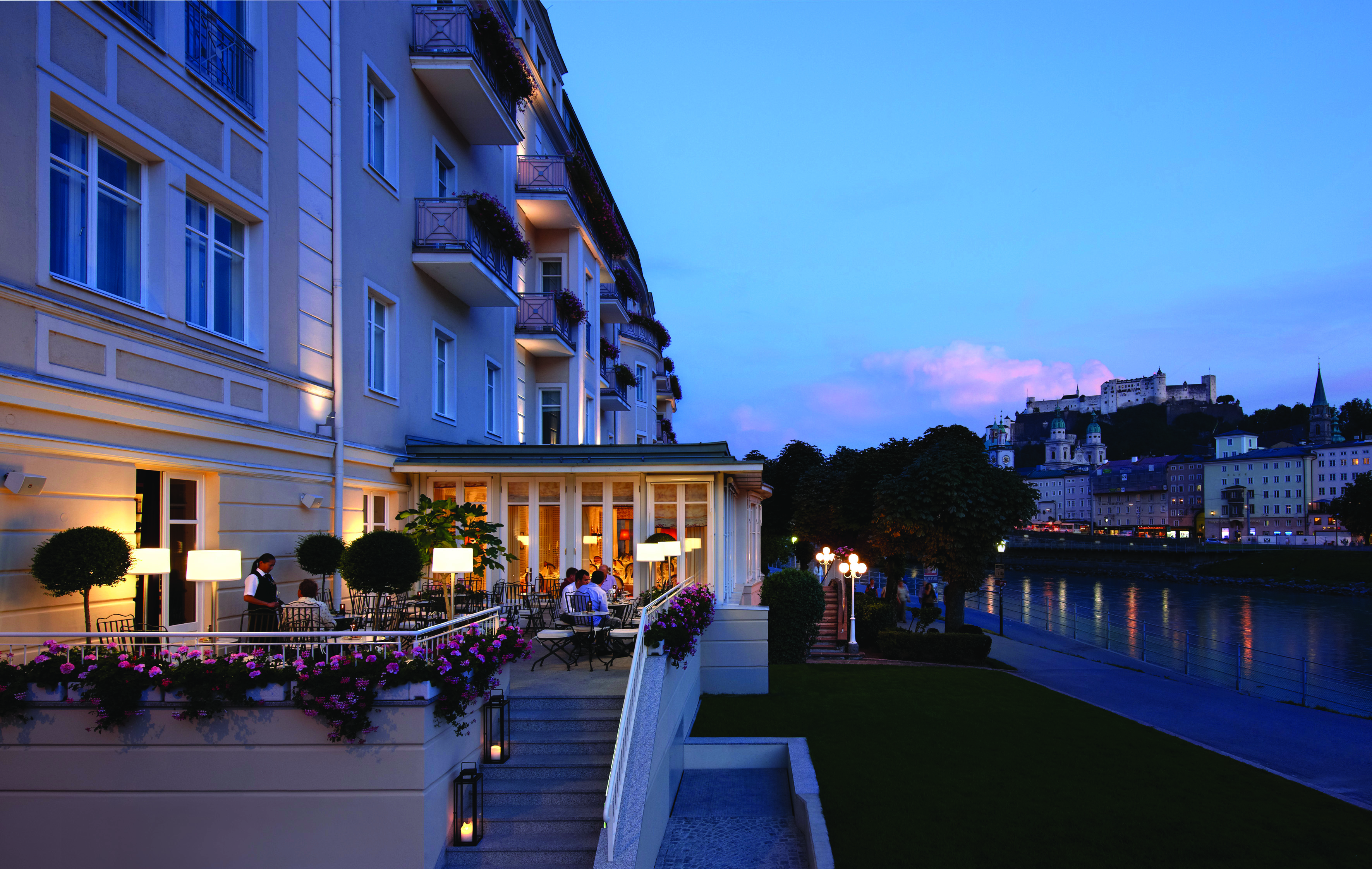 Hotel Sacher dining terrace overlooking the river, diners and waitress