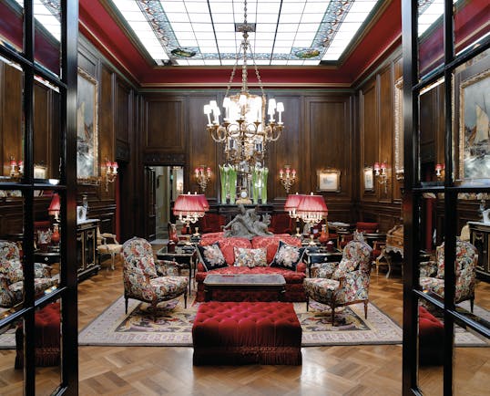 Hotel Sacher Vienna lobby seating area large glass skylight wooden walls and armchairs