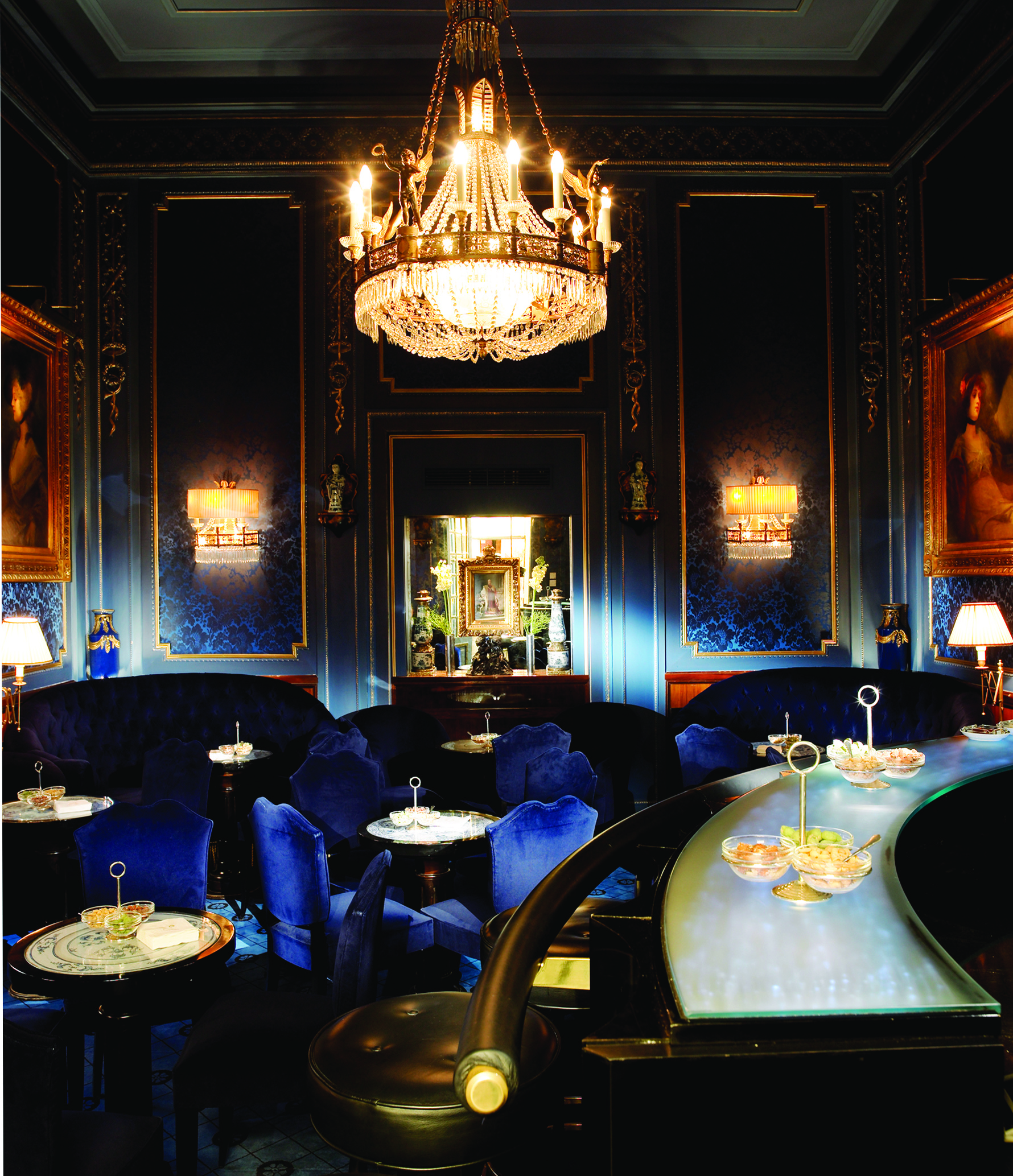Hotel Sacher Wien Blaue Bar ornate room with a large chandelier at the centre of the room, blue chairs and sofas occupy the room with large paintings on the walls