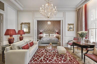Hotel Sacher Wien Philharmoniker Suite two rooms, one ith a double ed the other with a sofa and tables with a large overhanging chandelier