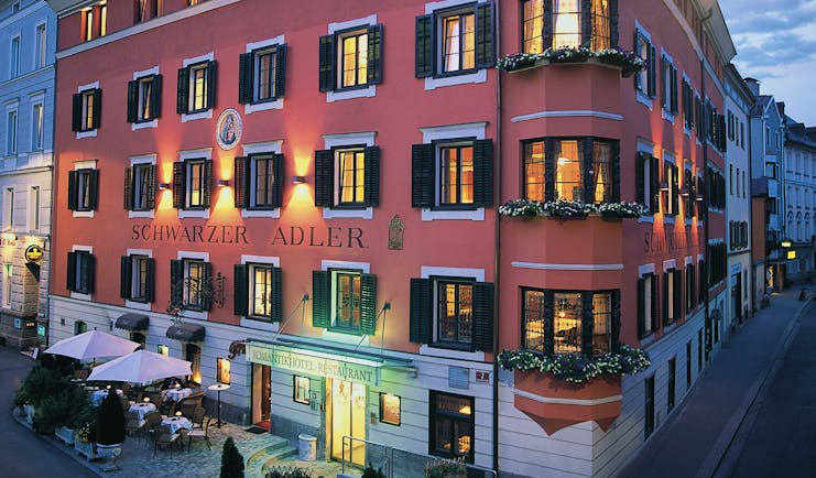 Hotel Schwarzer Adler exterior, grand red building on sreet corner