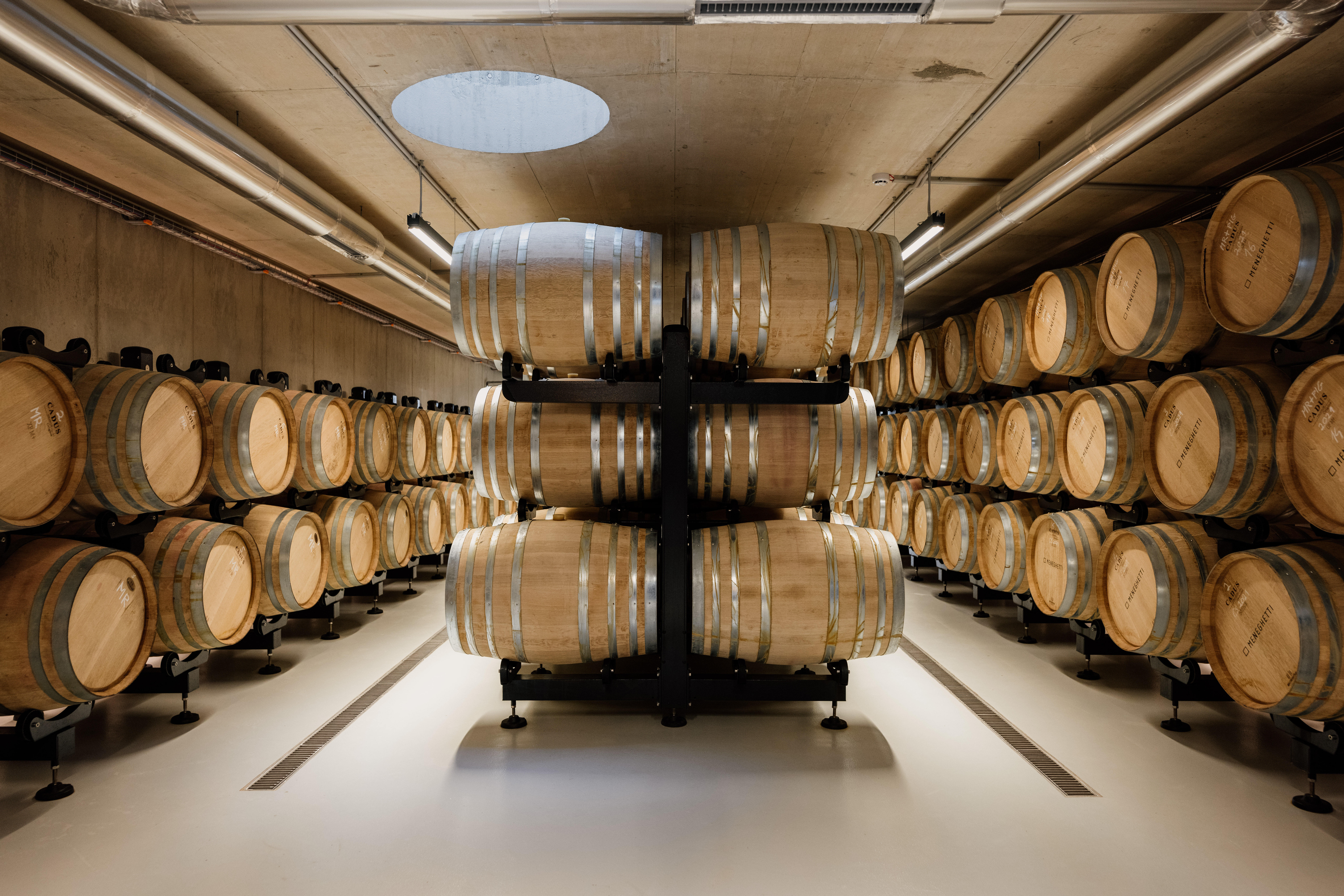 Meneghetti Wine Hotel winery with barrels stacked from floor to ceiling