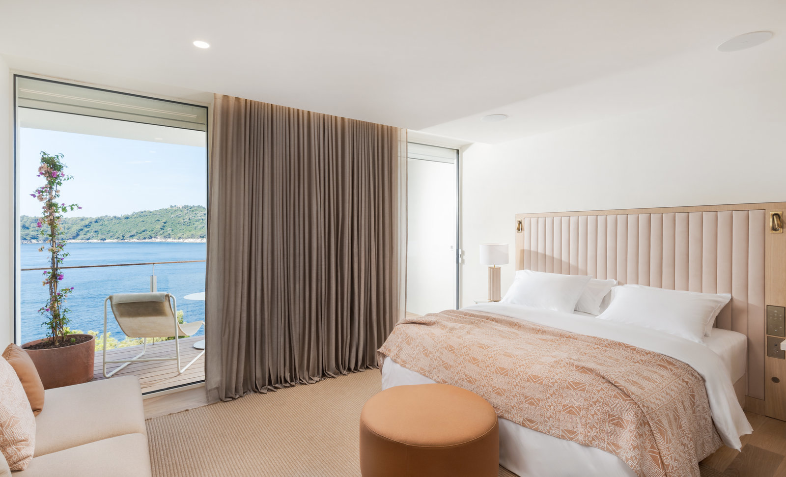 Villa Dubrovnik Deluxe Sea View Room with neutral colour palette, floor-to-ceiling windows, and sea views