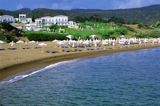 Anassa Hotel beach with white umbrellas and sunbeds 