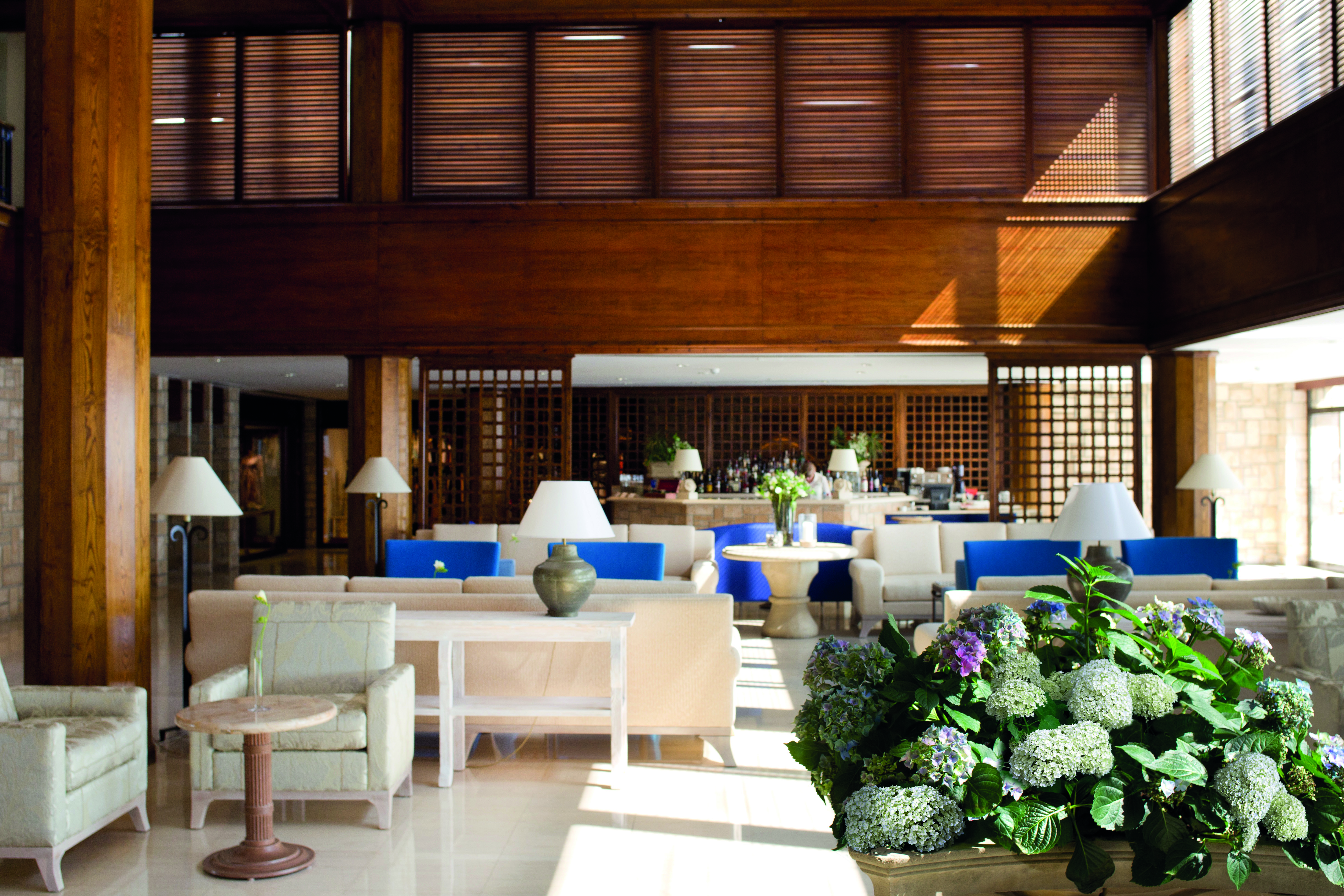 Annabelle Hotel Cyprus bar area with blue and white sofas and wooden walls and columns