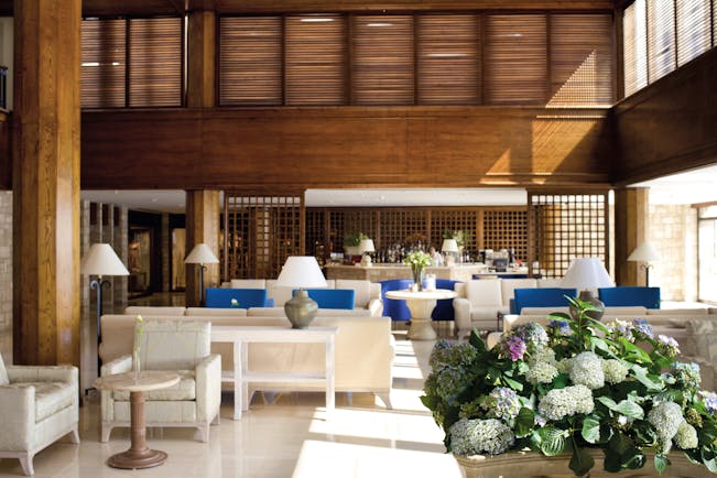Annabelle Hotel Cyprus bar area with blue and white sofas and wooden walls and columns