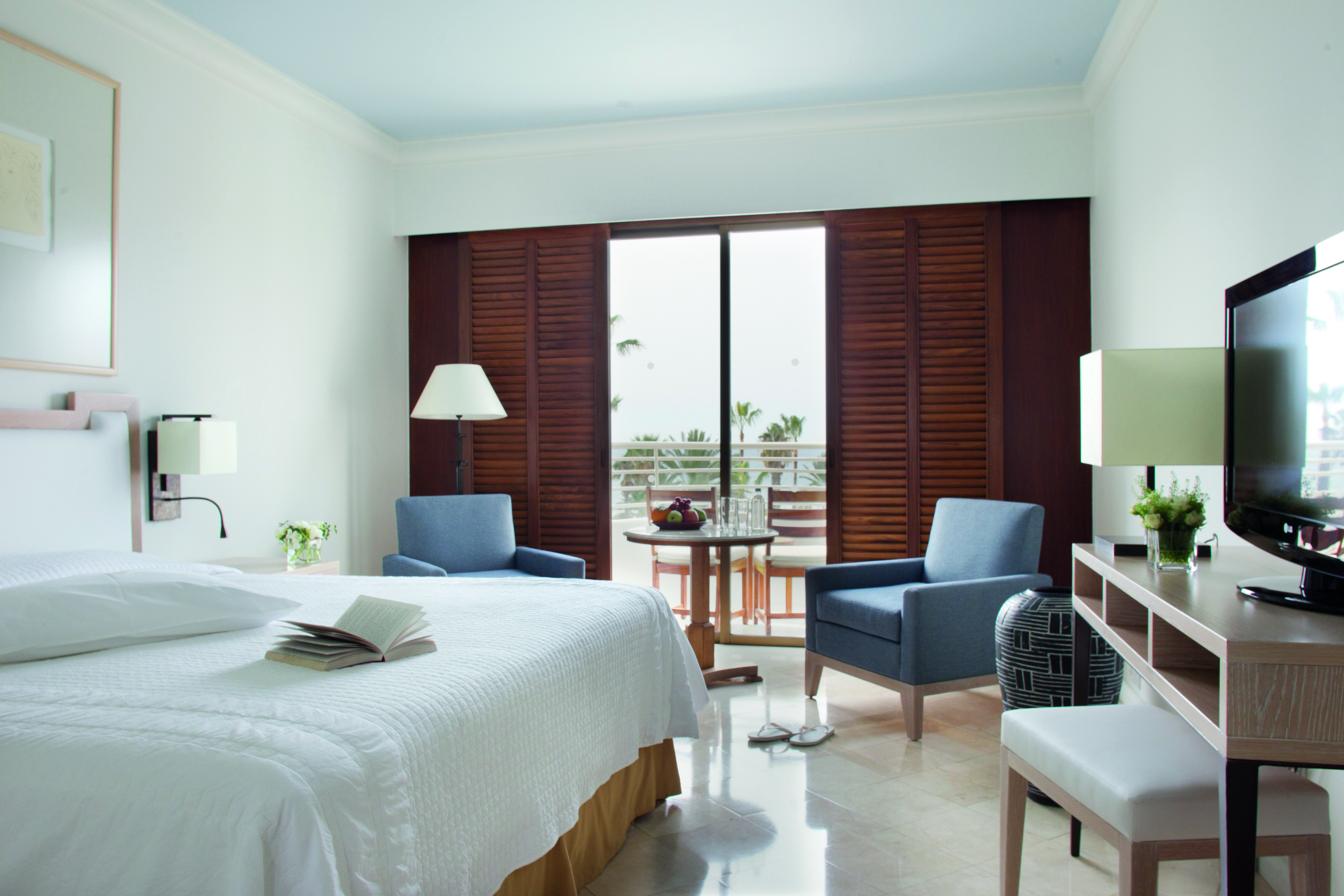 Annabelle Hotel Cyprus studio suite bedroom desk and wooden doors to a balcony