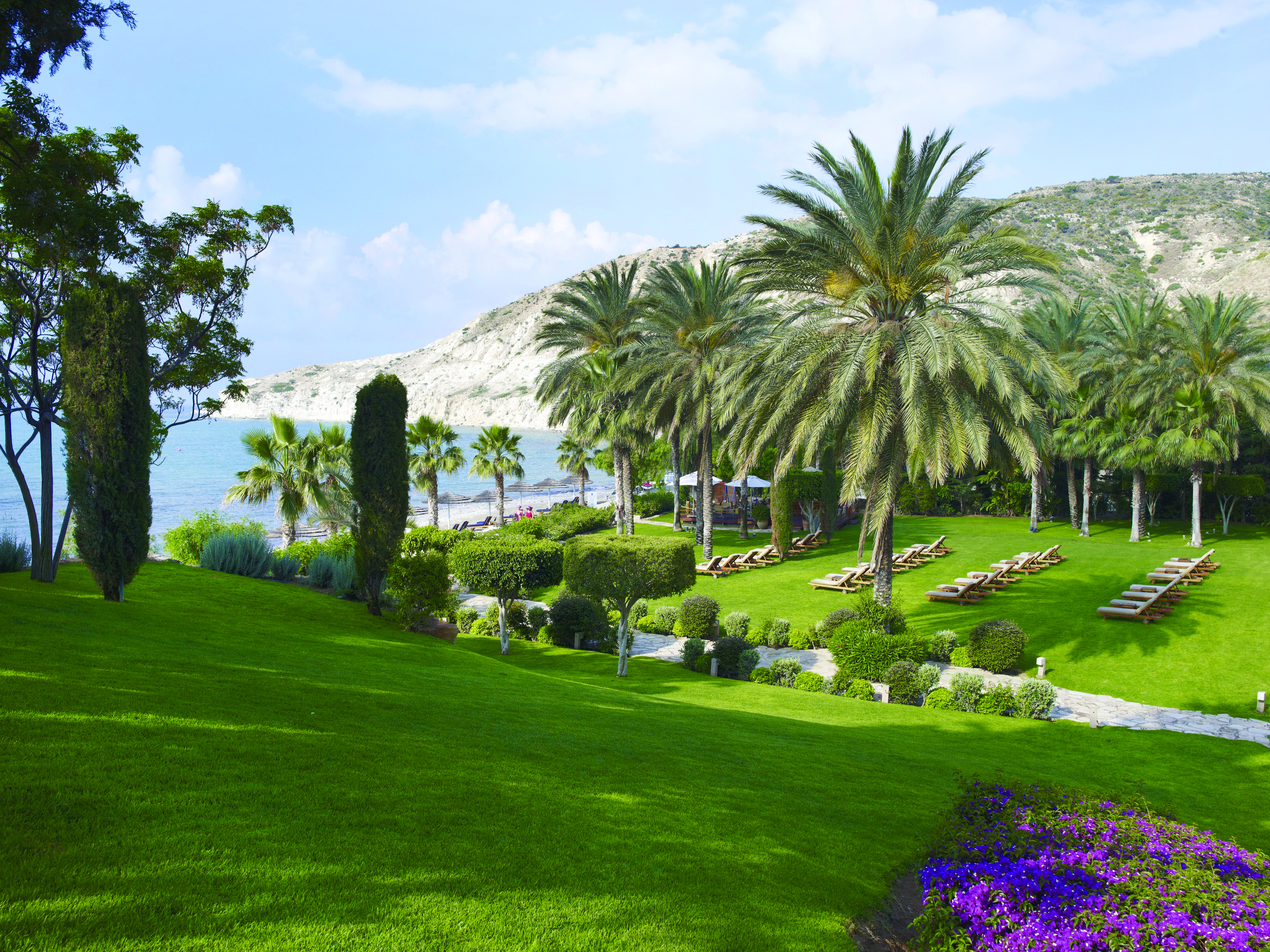 Columbia Beach Resort Cyprus gardens grounds sun loungers palm trees beach view