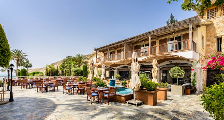 Columbia Beach Resort Cyprus outdoor dining terrace in front of a building with balconies