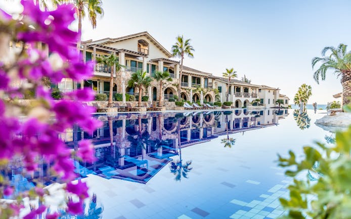 Columbia Beach Resort Cyprus panorama large white building with arches palms and swimming pool