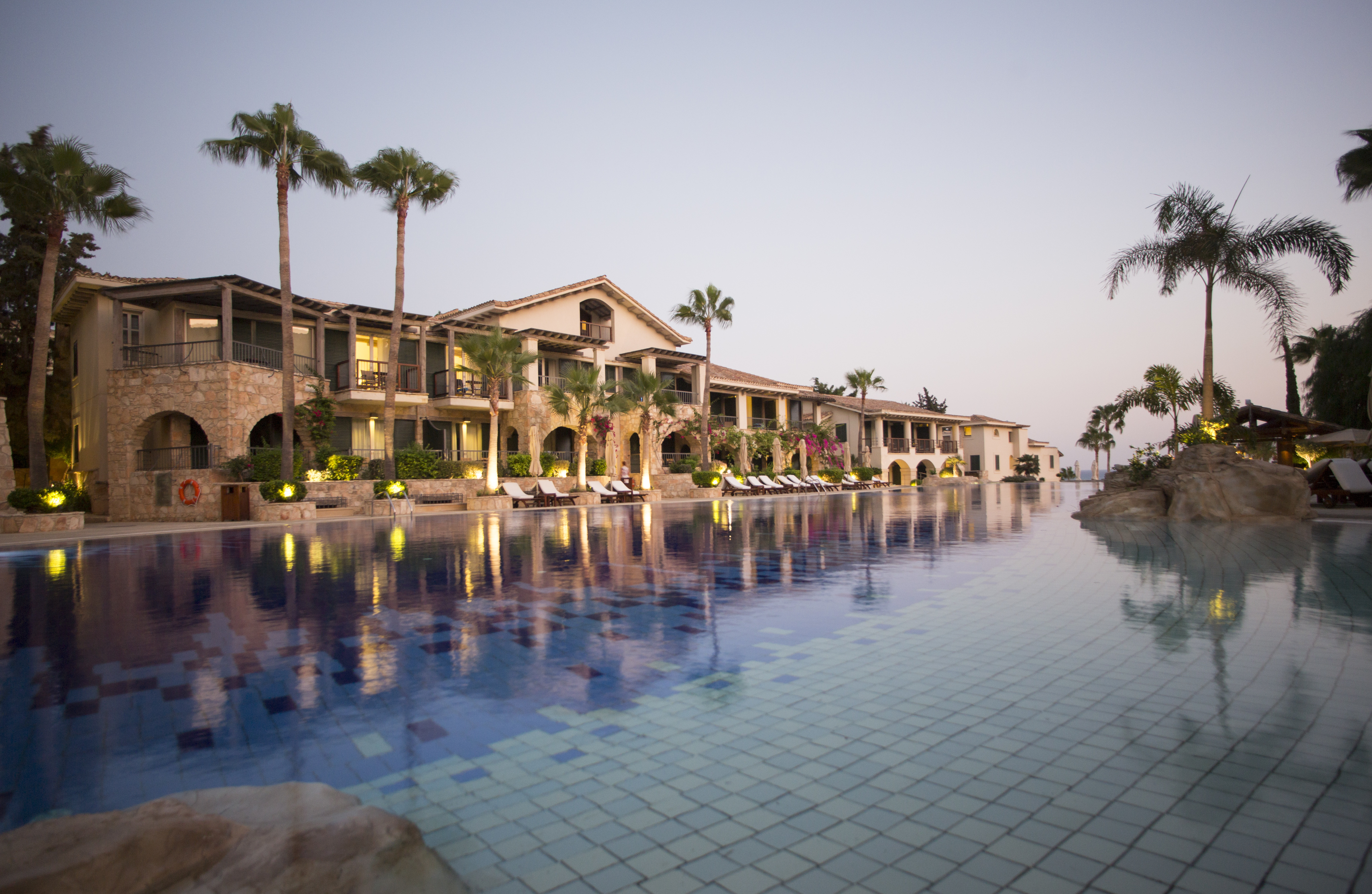 Columbia Beach Resort Cyprus outdoor pool and large building with palm trees and arches