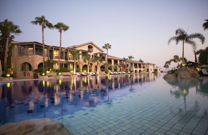 Columbia Beach Resort Cyprus outdoor pool and large building with palm trees and arches