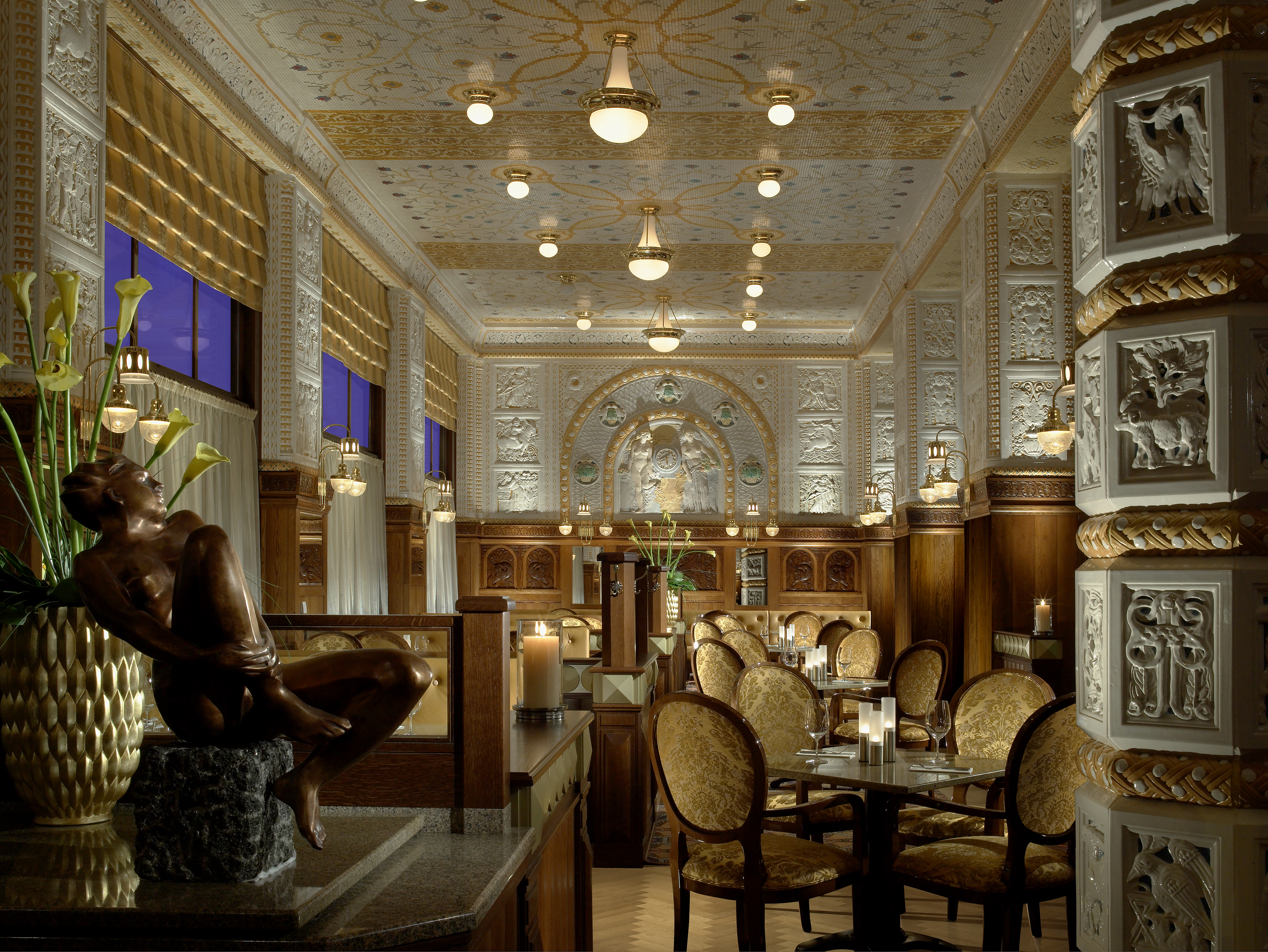 Art Deco Imperial resturant, grand lavish decor, statues, carved walls and columns, tables and chairs