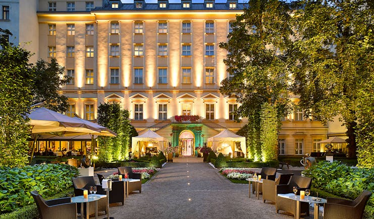 Grand Mark Prague exterior, hotel building, walkway to entrance with lawned gardens on each side, outdoor seating area