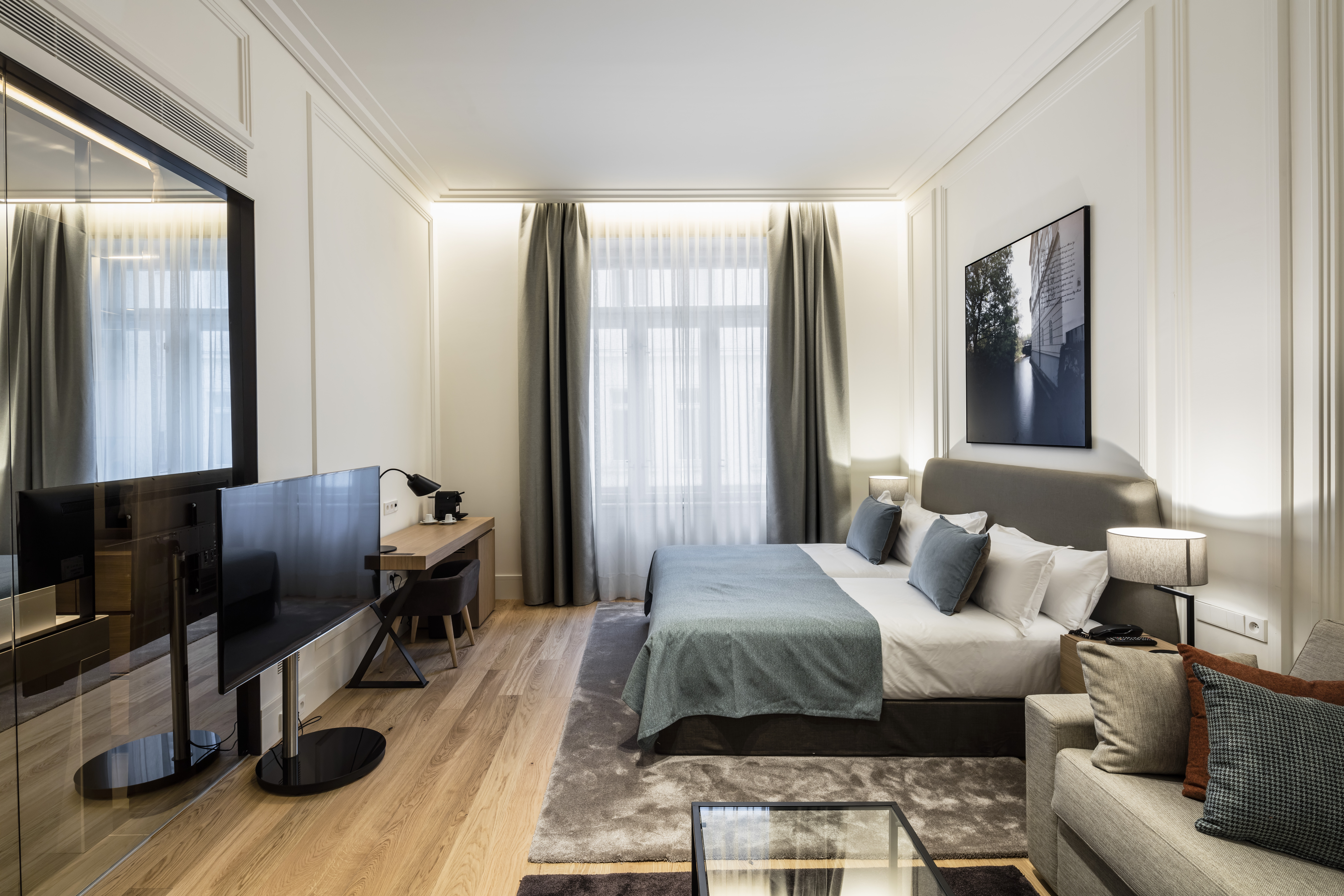 Hotel BoHo Prague junior suite bedroom sofa picture on the wall behind the bed large mirror