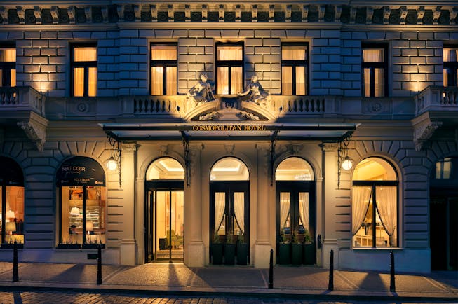 Hotel entrance at night with doors opening onto hotel