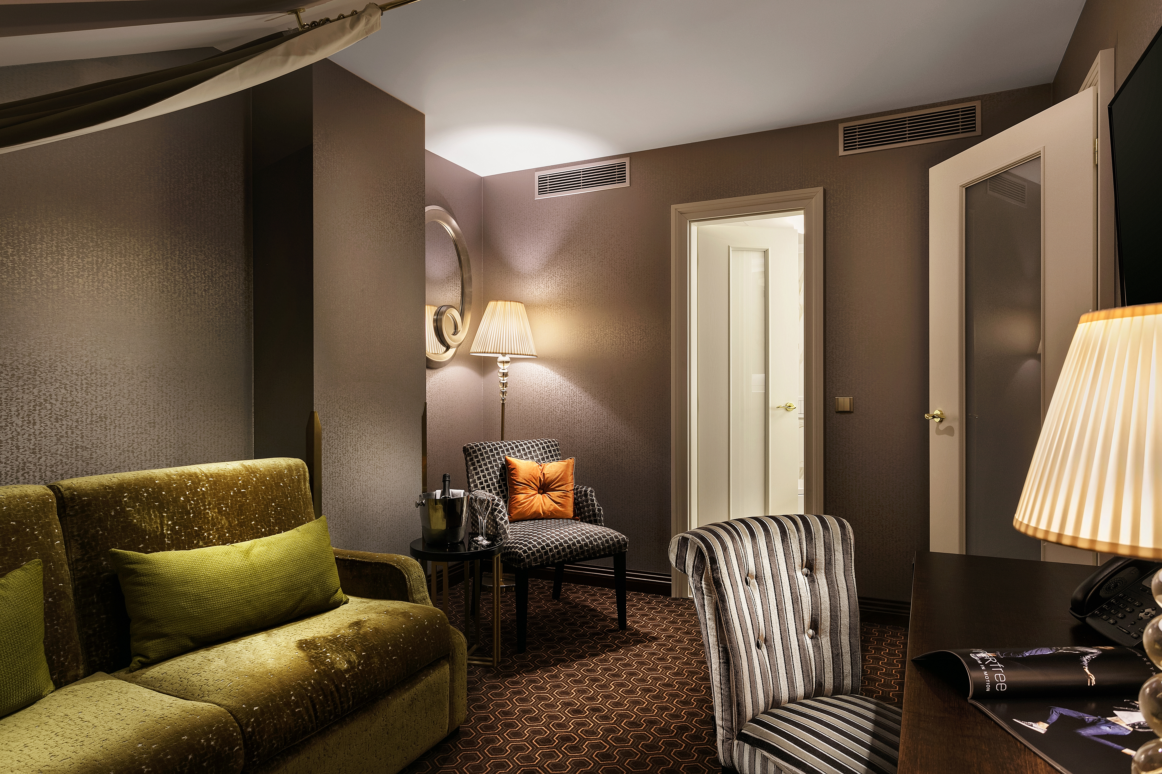 Suite living room with sofas, arm chairs and lampshades