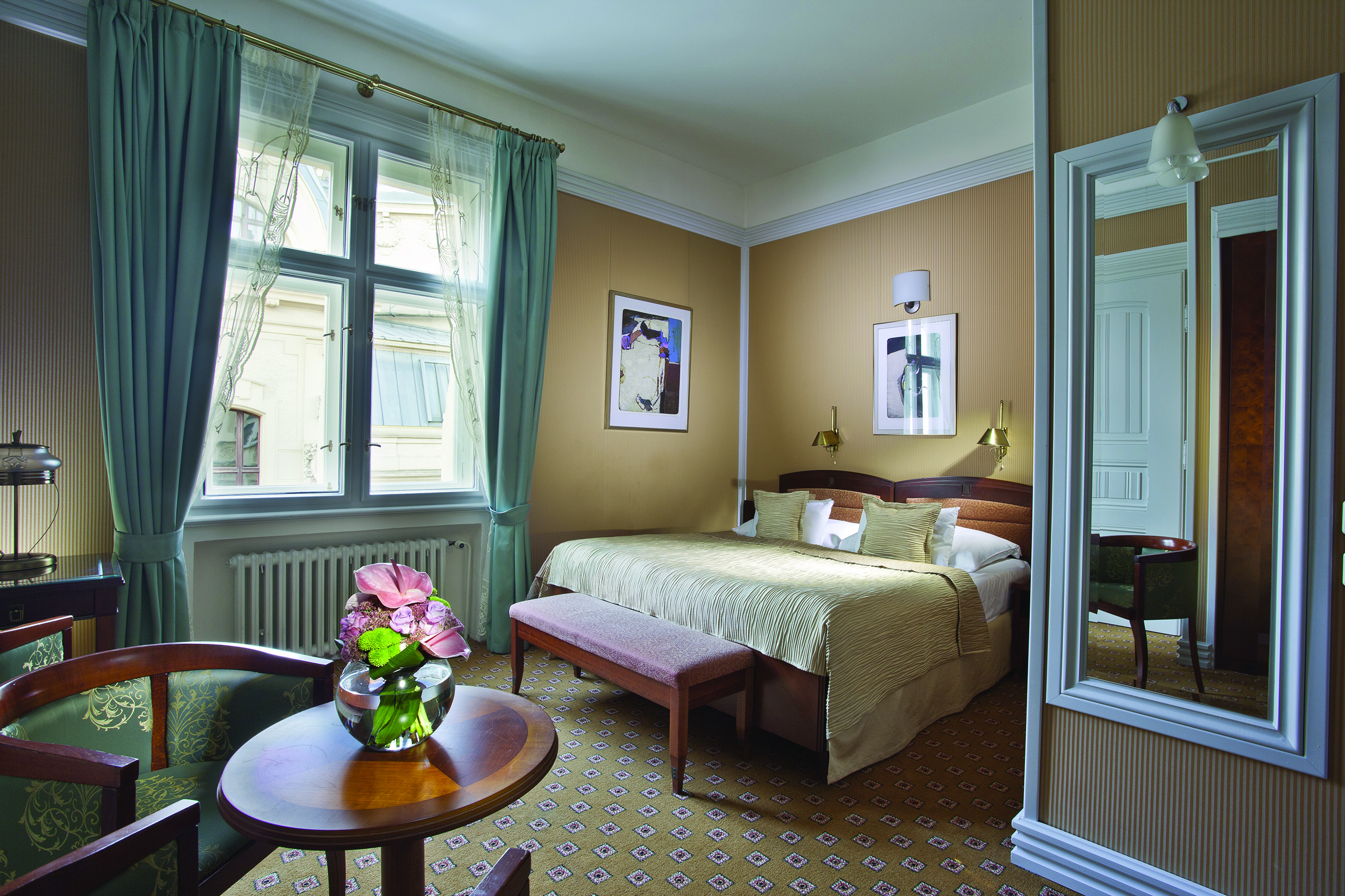 Hotel Paris Prague deluxe bedroom white mirror round table flowers and large window